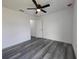 Bright bedroom features a ceiling fan and gray flooring creating a cozy and modern space at 17 Laurel Pass Ln, Ocala, FL 34480