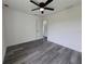 A bright bedroom features a modern ceiling fan and beautiful gray flooring, creating an inviting space at 17 Laurel Pass Ln, Ocala, FL 34480