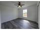 Bright bedroom featuring luxury vinyl plank flooring, a ceiling fan, and a window for natural light at 17 Laurel Pass Ln, Ocala, FL 34480