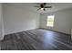 Bright bedroom with a ceiling fan, natural light, and sleek gray flooring at 17 Laurel Pass Ln, Ocala, FL 34480