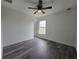 Bright bedroom featuring luxury vinyl plank flooring, a ceiling fan, and a window for natural light at 17 Laurel Pass Ln, Ocala, FL 34480