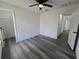Spacious bedroom with ceiling fan, gray flooring and multiple doorways for easy access at 17 Laurel Pass Ln, Ocala, FL 34480
