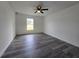 This bedroom features modern ceiling fan, luxury vinyl plank flooring, and a window for natural light at 17 Laurel Pass Ln, Ocala, FL 34480