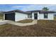 Newly constructed home with a black garage door and trim against a white stucco exterior at 17 Laurel Pass Ln, Ocala, FL 34480