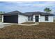 Newly constructed home with a black garage door and trim against a white stucco exterior at 17 Laurel Pass Ln, Ocala, FL 34480