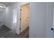 Bright hallway featuring luxury vinyl plank flooring, white walls, and visible doorways at 17 Laurel Pass Ln, Ocala, FL 34480