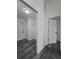 Hallway offers access to a laundry room with shelving and other rooms, ensuring seamless living at 17 Laurel Pass Ln, Ocala, FL 34480