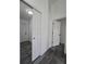 Hallway with white doors and trim, complemented by sleek gray flooring throughout at 17 Laurel Pass Ln, Ocala, FL 34480
