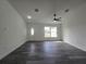 Bright living room featuring wood flooring, modern ceiling fan, and a front door with a window at 17 Laurel Pass Ln, Ocala, FL 34480