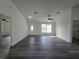 A bright living room offers modern lighting, hardwood floors, and a welcoming entry door at 17 Laurel Pass Ln, Ocala, FL 34480