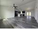 Open-concept living space with hardwood flooring, modern lighting, and a glimpse into the kitchen at 17 Laurel Pass Ln, Ocala, FL 34480