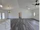 A modern living room features luxury vinyl plank flooring, recessed lights, and stylish chandelier at 17 Laurel Pass Ln, Ocala, FL 34480