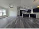 Open concept living room with luxury vinyl plank flooring, recessed lighting, and bright kitchen at 17 Laurel Pass Ln, Ocala, FL 34480