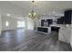 Inviting kitchen and living space, illuminated by modern lighting and complemented by a kitchen island at 17 Laurel Pass Ln, Ocala, FL 34480