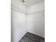 An open walk-in closet with wire shelving, gray flooring and white walls offers ample storage at 17 Laurel Pass Ln, Ocala, FL 34480