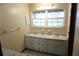 Bathroom with white double sink vanity, neutral walls, and ample lighting at 1764 Se 169Th Avenue Rd, Silver Springs, FL 34488