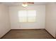 Bright bedroom features a ceiling fan, wood-look floors, and natural light from a window at 1764 Se 169Th Avenue Rd, Silver Springs, FL 34488