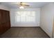 Bedroom with vinyl flooring features a large window and closet space at 1764 Se 169Th Avenue Rd, Silver Springs, FL 34488