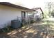 Side exterior of the home with AC unit, fenced yard, and landscaping at 1764 Se 169Th Avenue Rd, Silver Springs, FL 34488