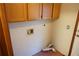 Laundry room area with tile floor, plumbing hookups, and overhead storage cabinet at 1764 Se 169Th Avenue Rd, Silver Springs, FL 34488
