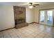Living room features a brick fireplace, tile flooring, and access to the lanai at 1764 Se 169Th Avenue Rd, Silver Springs, FL 34488