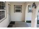 Covered patio with decorative arches, exterior door, and windows at 1764 Se 169Th Avenue Rd, Silver Springs, FL 34488