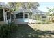 Screened-in pool area featuring an in-ground pool surrounded by mature landscaping in the yard at 1764 Se 169Th Avenue Rd, Silver Springs, FL 34488