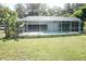 Screened-in pool provides a private outdoor oasis surrounded by lush green lawn at 1764 Se 169Th Avenue Rd, Silver Springs, FL 34488