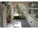Covered porch featuring arched openings and view of lush landscaping at 1764 Se 169Th Avenue Rd, Silver Springs, FL 34488