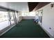 Enclosed sunroom with green carpet, patio doors, and view of the outdoors at 1764 Se 169Th Avenue Rd, Silver Springs, FL 34488