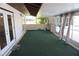 Enclosed sunroom with green carpet, patio doors, and view of the outdoors at 1764 Se 169Th Avenue Rd, Silver Springs, FL 34488