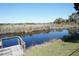 Beautiful waterfront view of a tranquil creek from a weathered wooden dock on the property at 1764 Se 169Th Avenue Rd, Silver Springs, FL 34488