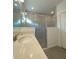 Bright bathroom featuring a glass shower enclosure, quartz countertop, and gray flooring at 19444 Sw 78Th Pl, Dunnellon, FL 34432