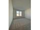 Spacious bedroom with plush carpeting and a window offering natural light at 19444 Sw 78Th Pl, Dunnellon, FL 34432