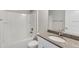 Bathroom featuring a granite countertop, a toilet, a shower and tub combo with white tiled walls at 211 Oak Lane Cir, Ocala, FL 34472