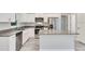 Bright kitchen features an island, stainless steel appliances and granite countertops at 211 Oak Lane Cir, Ocala, FL 34472