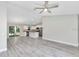 Open concept living space with gray vinyl floors, a kitchen, and sliding glass doors to the patio at 211 Oak Lane Cir, Ocala, FL 34472