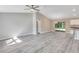 Spacious open-concept living area with light gray walls, vinyl flooring, and sliding glass doors at 211 Oak Lane Cir, Ocala, FL 34472