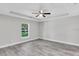 Serene bedroom featuring vinyl plank flooring, recessed lighting, and a bright window at 211 Oak Lane Cir, Ocala, FL 34472