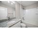 Bright bathroom featuring a shower-tub, granite countertop, and ample lighting at 217 Oak Lane Cir, Ocala, FL 34472