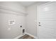 Functional laundry room with hookups, shelving, and a door for easy access at 217 Oak Lane Cir, Ocala, FL 34472