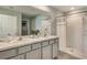 Bathroom showcasing a double sink vanity, large mirror, and a shower with a shower curtain at 2426 Sw 168Th Loop, Ocala, FL 34473