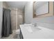 Bathroom featuring a shower with tile surround, a gray vanity and an framed mirror at 3010 Sw 137Th Pl, Ocala, FL 34473