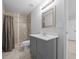 Bathroom featuring a shower with tile surround, a gray vanity and an framed mirror at 3010 Sw 137Th Pl, Ocala, FL 34473