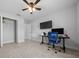 Bedroom includes tile floors, closet, ceiling fan, and an area with a desk and computer at 3010 Sw 137Th Pl, Ocala, FL 34473