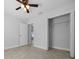Bedroom featuring a ceiling fan, closet, and doorway leading to another area at 3010 Sw 137Th Pl, Ocala, FL 34473
