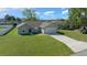 Charming single-story home with a well-manicured lawn and attached two-car garage at 3010 Sw 137Th Pl, Ocala, FL 34473