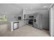 Modern kitchen with stainless steel appliances, tiled floor, light gray cabinets, and a kitchen island at 3010 Sw 137Th Pl, Ocala, FL 34473