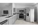 Stylish kitchen boasts stainless steel appliances, tiled flooring, and ample counter space at 3010 Sw 137Th Pl, Ocala, FL 34473