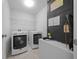 Laundry room with washer, dryer, shelving, and tile flooring at 3010 Sw 137Th Pl, Ocala, FL 34473